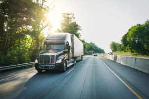 semi truck driving down highway 