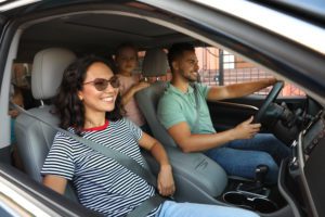 Happy family traveling by car on summer day