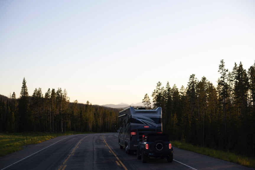 rear-view of a motorcoach flat towing a jeep using a flat tow brake